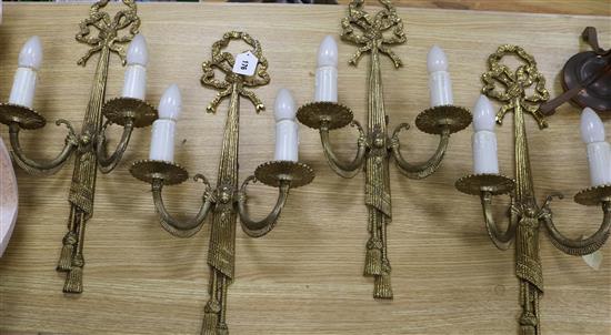 A set of four Louis XVI style gilt metal two branch wall lights length 57cm